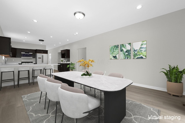 dining area featuring light wood-style floors, baseboards, and recessed lighting