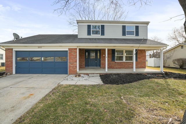 traditional-style house featuring brick siding, covered porch, a front yard, a garage, and driveway