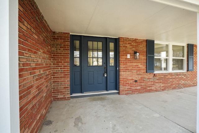 doorway to property with brick siding