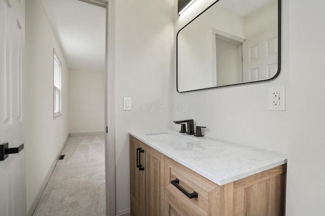 bathroom featuring baseboards and vanity