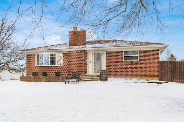 view of snow covered rear of property