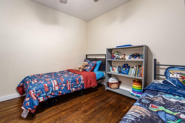 bedroom with dark hardwood / wood-style floors and ceiling fan