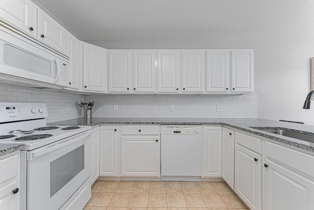 kitchen featuring sink, white appliances, and white cabinets