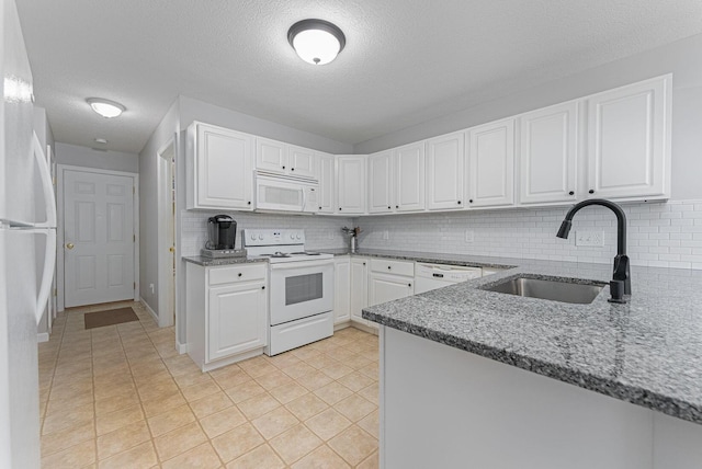 kitchen featuring sink, white appliances, white cabinetry, and tasteful backsplash