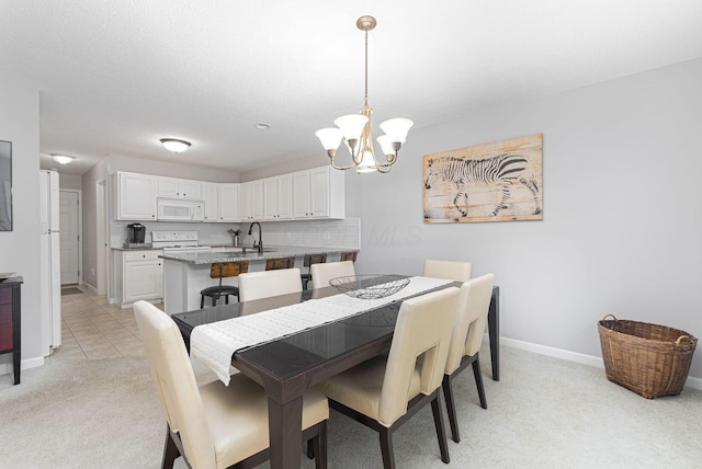 dining space with sink, an inviting chandelier, and light carpet