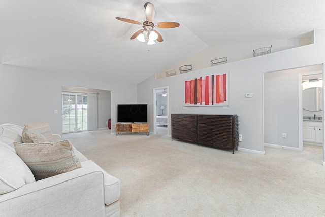 carpeted living room with sink, vaulted ceiling, and ceiling fan