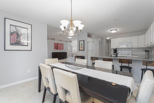 dining space with an inviting chandelier