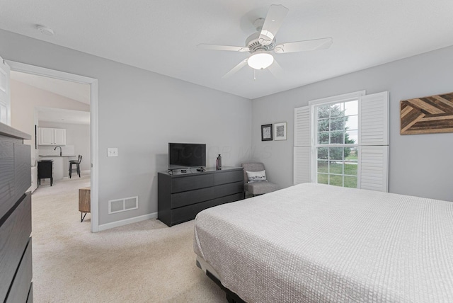 bedroom featuring light carpet and ceiling fan