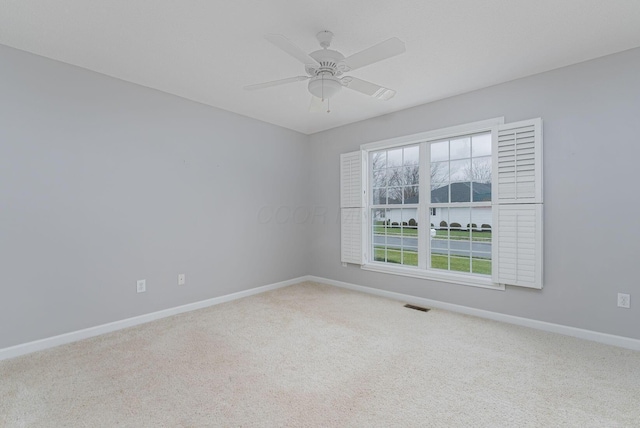 unfurnished room featuring ceiling fan and carpet floors