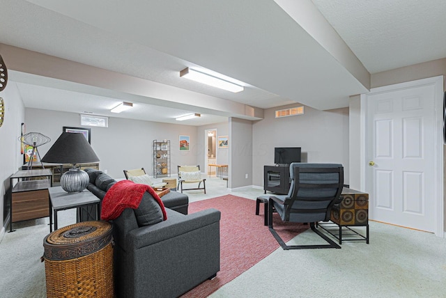 living room with light carpet and a textured ceiling