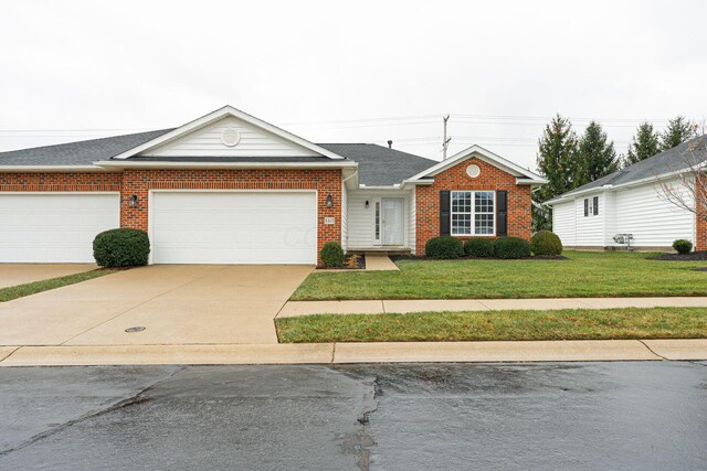 ranch-style home featuring a front yard and a garage