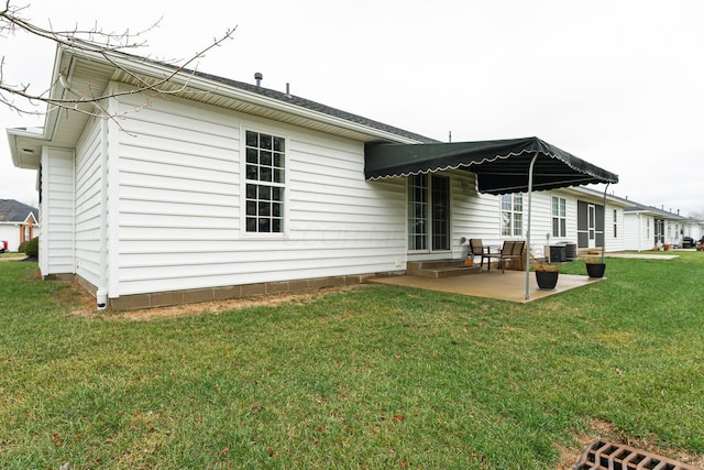 rear view of house featuring central AC unit, a lawn, and a patio area