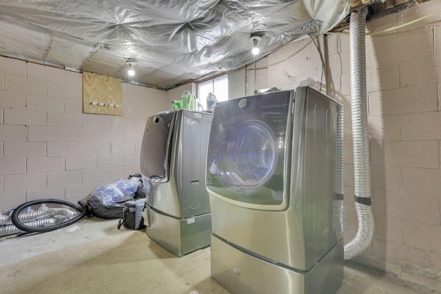 washroom with laundry area and washer / dryer