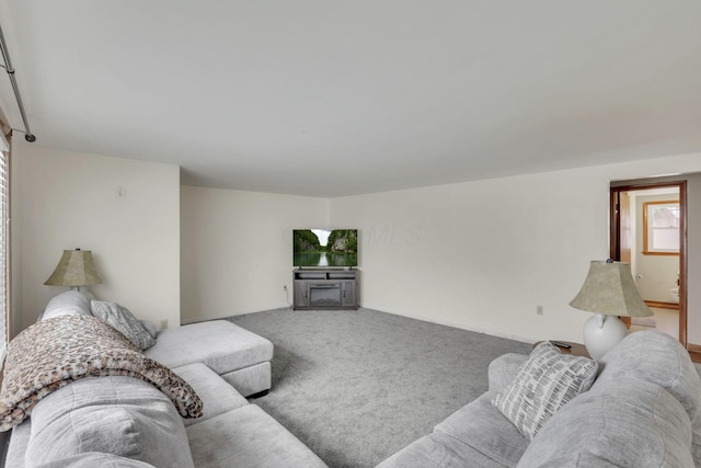 carpeted living room featuring a fireplace