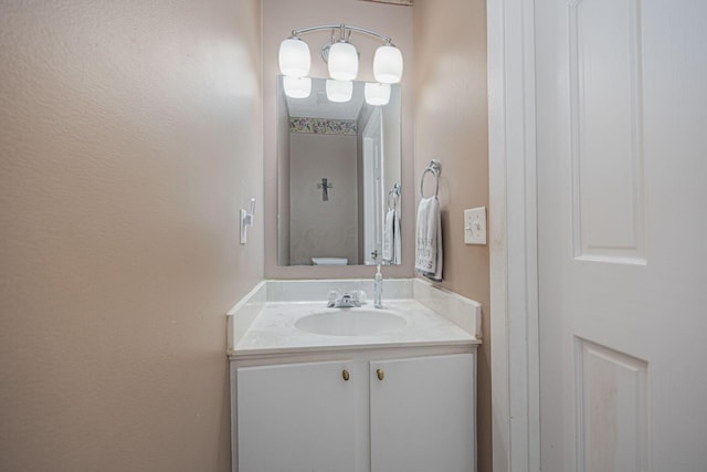 bathroom featuring toilet and vanity