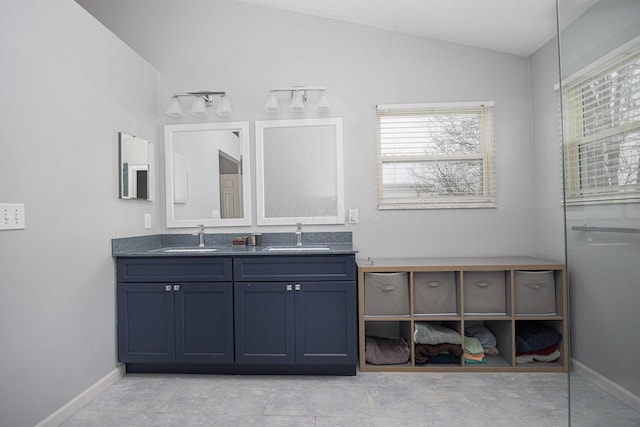 bathroom with lofted ceiling and vanity