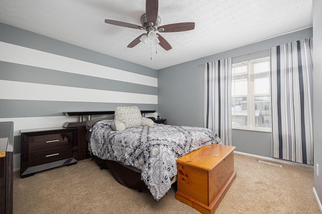 bedroom with ceiling fan, a textured ceiling, and light colored carpet