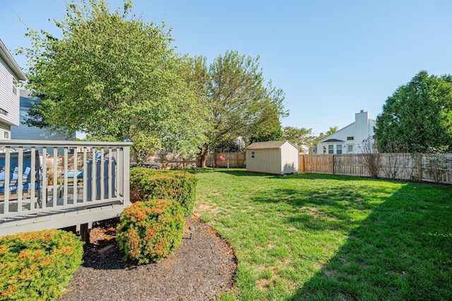 view of yard with a shed and a wooden deck