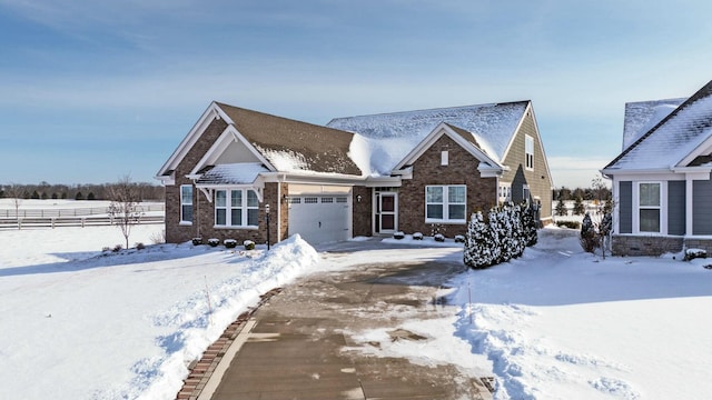 craftsman-style house featuring an attached garage and brick siding