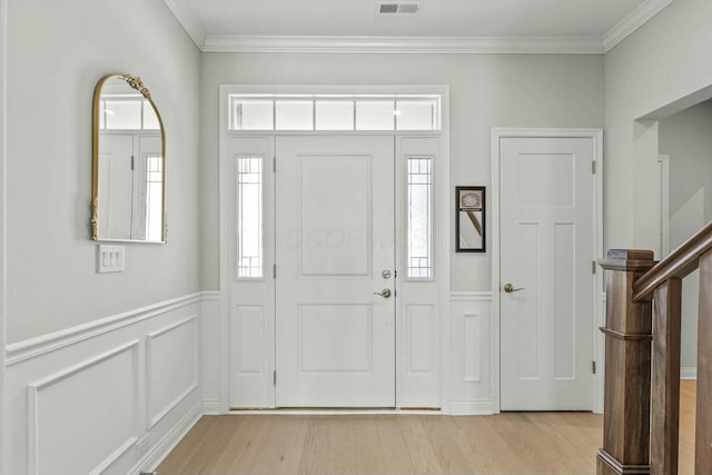 entrance foyer featuring light hardwood / wood-style floors and ornamental molding