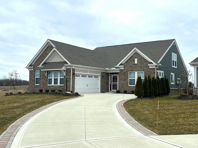 craftsman-style home with a garage, concrete driveway, brick siding, and a front lawn