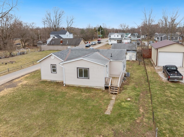 2029 Fairfax Ave, Columbus, OH 43207 - rear view of house featuring a residential view, a lawn, a detached garage, and fence
