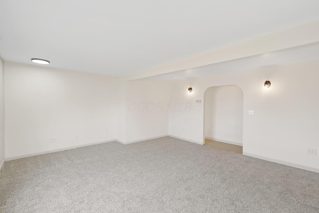 2029 Fairfax Ave, Columbus, OH 43207 - empty room featuring arched walkways, light carpet, and baseboards