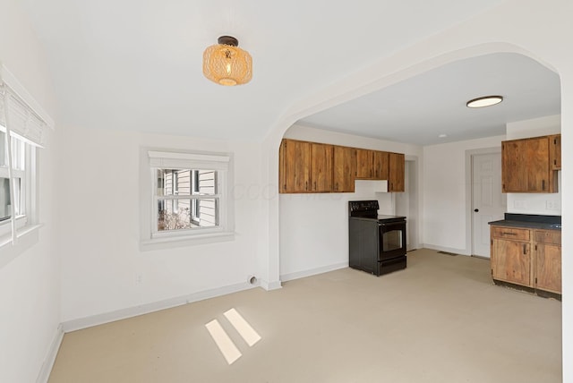 2029 Fairfax Ave, Columbus, OH 43207 - kitchen featuring baseboards, arched walkways, black electric range oven, and brown cabinets