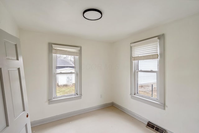 2029 Fairfax Ave, Columbus, OH 43207 - spare room with finished concrete flooring, baseboards, and visible vents