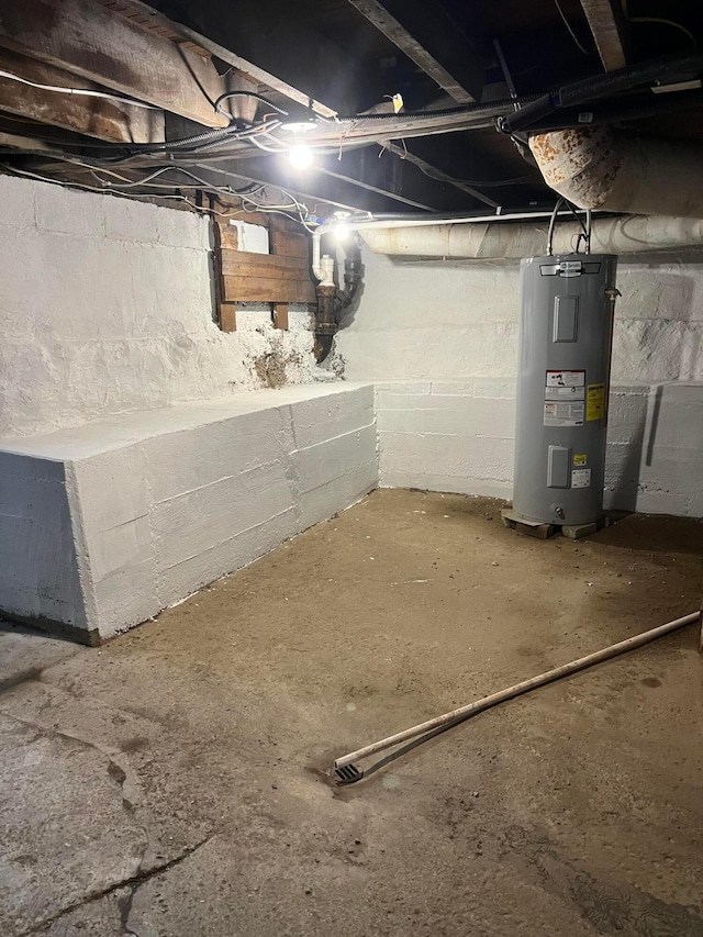 unfinished below grade area featuring electric water heater