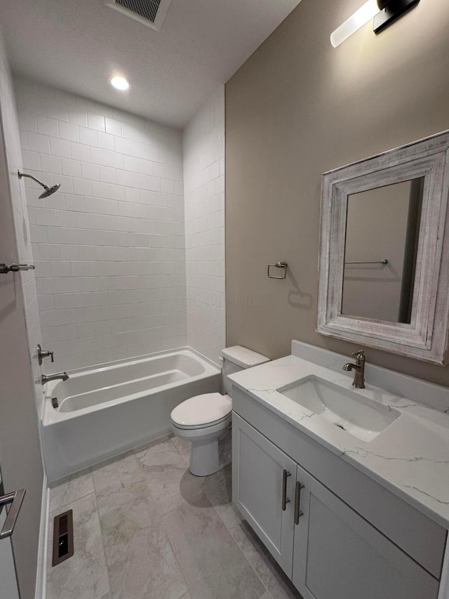 bathroom featuring visible vents, toilet, shower / bathing tub combination, vanity, and marble finish floor