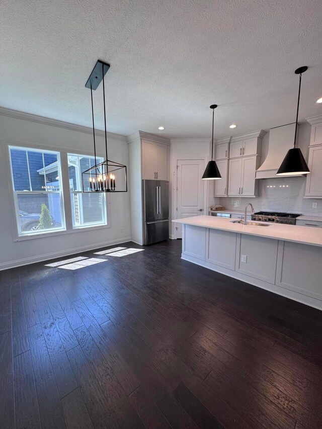 5450 Maple Dr, Lewis Center, OH 43035 - kitchen with dark wood-style flooring, a sink, custom exhaust hood, high quality fridge, and light countertops