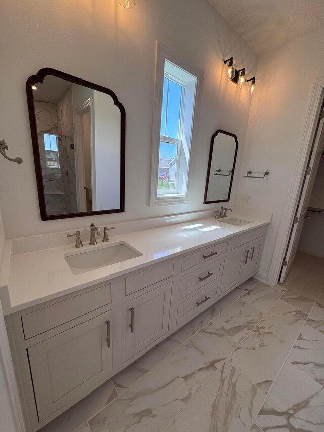 5450 Maple Dr, Lewis Center, OH 43035 - bathroom with double vanity, walk in shower, marble finish floor, and a sink