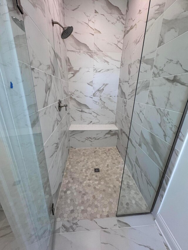 5450 Maple Dr, Lewis Center, OH 43035 - bathroom featuring a tile shower and marble finish floor