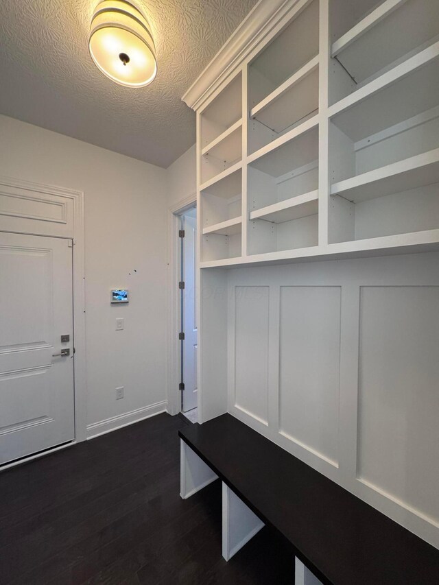 5450 Maple Dr, Lewis Center, OH 43035 - mudroom featuring a textured ceiling, dark wood-style flooring, and baseboards