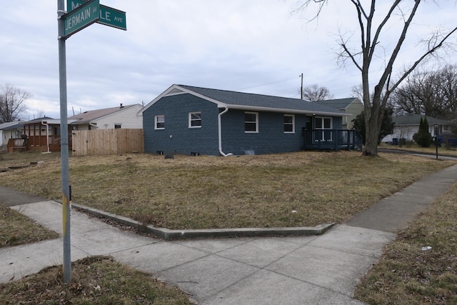 view of front of house featuring brick siding, crawl space, a front yard, and fence