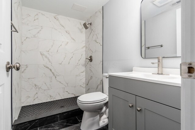 full bathroom featuring toilet, a shower stall, visible vents, and vanity