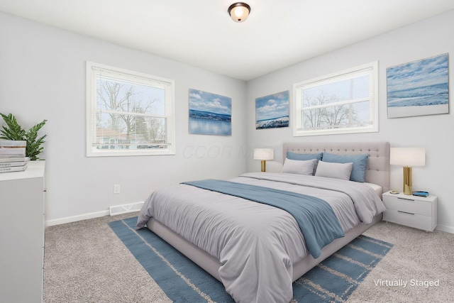 carpeted bedroom featuring visible vents and baseboards