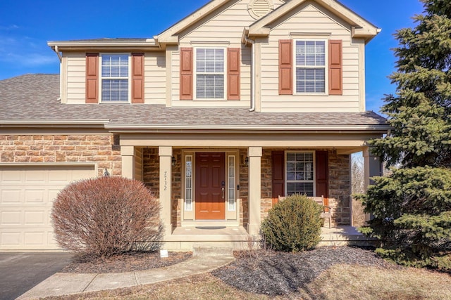 view of front of property with covered porch and a garage