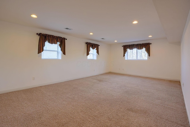 carpeted spare room with a wealth of natural light