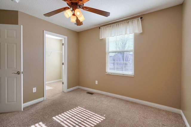 unfurnished room featuring ceiling fan and light colored carpet