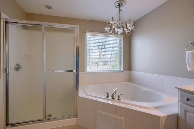 bathroom featuring plus walk in shower, vanity, an inviting chandelier, and lofted ceiling