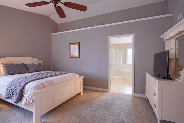 bedroom featuring light carpet, vaulted ceiling, connected bathroom, and ceiling fan