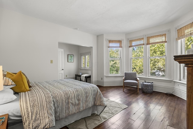 bedroom featuring a textured ceiling and dark wood-type flooring