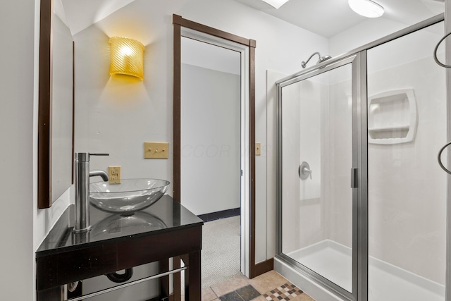 bathroom featuring walk in shower and double sink