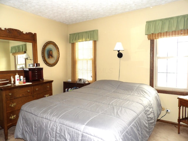 carpeted bedroom with a textured ceiling