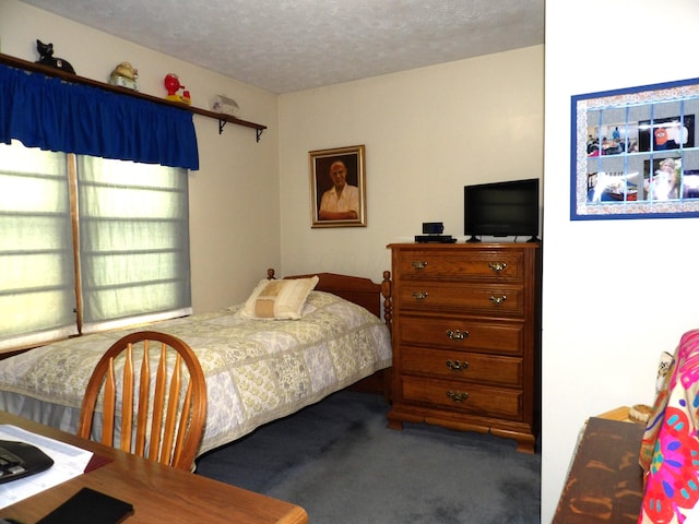 carpeted bedroom with a textured ceiling