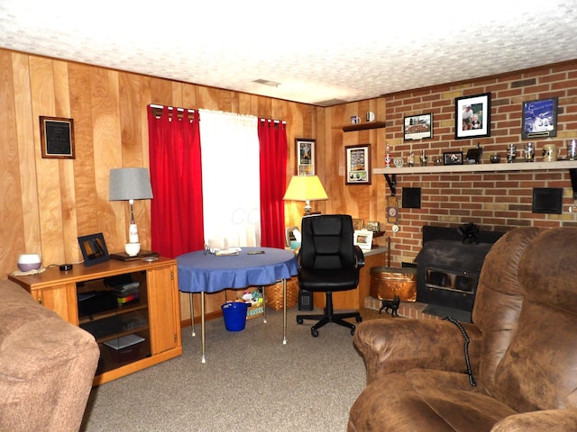 carpeted living room featuring a textured ceiling and wooden walls