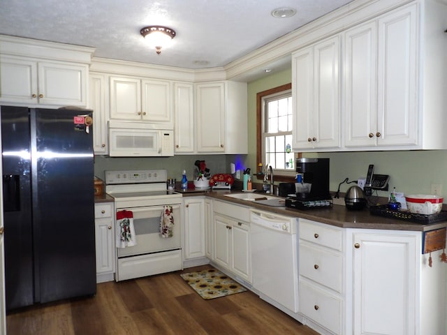 kitchen with sink, white appliances, white cabinetry, and dark hardwood / wood-style floors