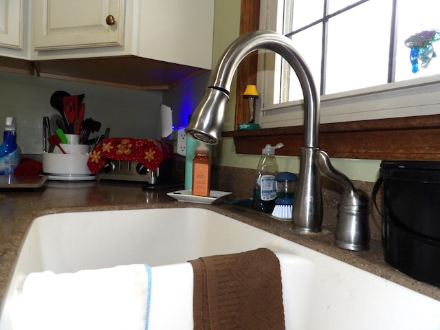 interior details with sink and cream cabinetry